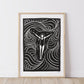 Framed black and white artwork of a woman with floating in the ocean with flowing lines of movement