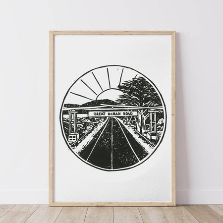 Framed artwork of a black and white lino print of the iconic road sign 'Great Ocean Road'.