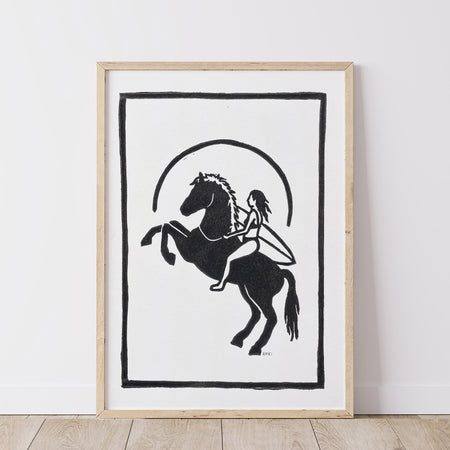 Framed artwork of a black silhouette of a girl on a horse with a surfboard against a white background